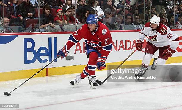 Alexei Kovalev of the Montreal Canadiens stickhandles the puck away from the reach of Ed Jovanovski of the Phoenix Coyotes at the Bell Centre on...