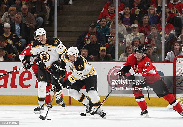 Dany Heatley of the Ottawa Senators chases Marco Sturm of the Boston Bruins at Scotiabank Place on October 18, 2008 in Ottawa, Ontario, Canada.