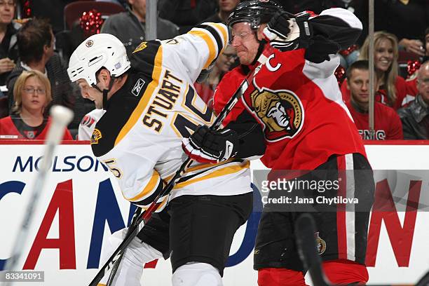 Daniel Alfredsson of the Ottawa Senators battles for the puck with Mark Stuart of the Boston Bruins at Scotiabank Place on October 18, 2008 in...