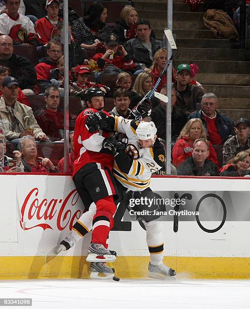 Filip Kuba of the Ottawa Senators collies with Shawn Thornton of the Boston Bruins at Scotiabank Place on October 18, 2008 in Ottawa, Ontario, Canada.