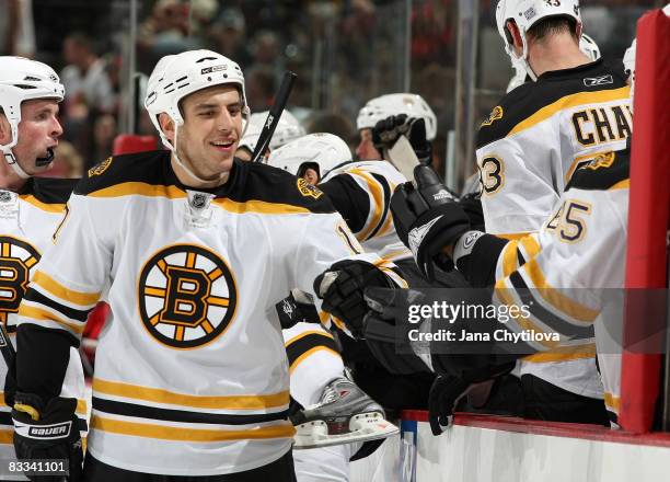 Milan Lucic of the Boston Bruins celebrates his goal against the Ottawa Senators with his team mates on the bench at Scotiabank Place on October 18,...