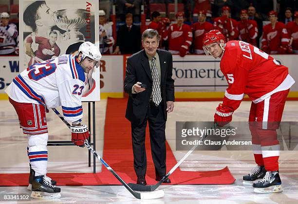 Detroit Red Wing legend Ted Lindsay drops the puck between Chris Drury of the New York Rangers and Nicklas Lidstrom of the Detroit Red Wings in a...