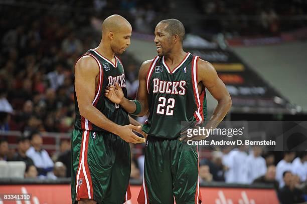 Michael Redd talks to teammate Richard Jefferson of the Milwaukee Bucks during the game against the Golden State Warriors at the Beijing Olympic...
