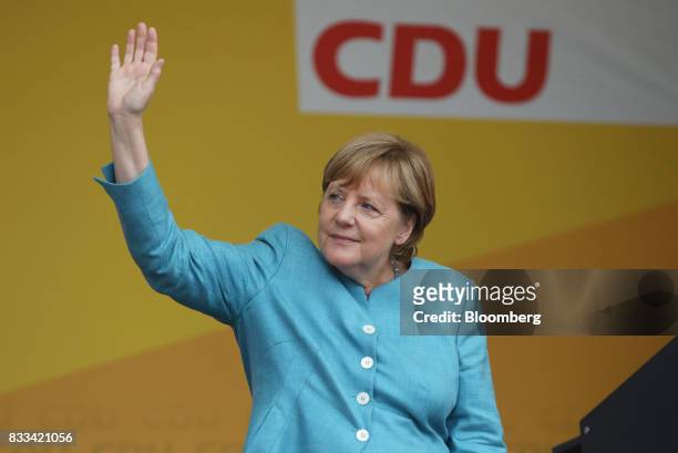 Angela Merkel, Germany's chancellor and Christian Democratic Union leader, waves to supporters during an election campaign stop in Koblenz, Germany,...