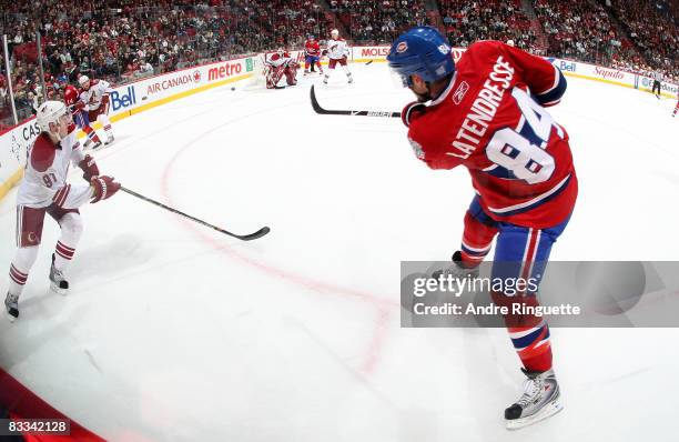 Guillaume Latendresse of the Montreal Canadiens fires a shot against the Phoenix Coyotes' net at the Bell Centre on October 18, 2008 in Montreal,...