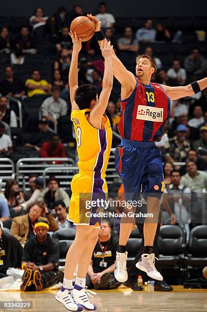 Sun Yue of the Los Angeles Lakers has his shot blocked by David Anderson of Regal FC Barcelona at Staples Center on October 18, 2008 in Los Angeles,...