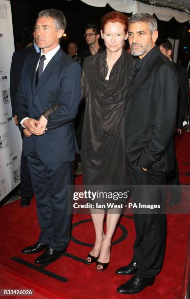 From left; Director Tony Gilroy, Tilda Swinton and George Clooney arriving at the premiere for new film Michael Clayton, at the Roy Thomson Hall in...