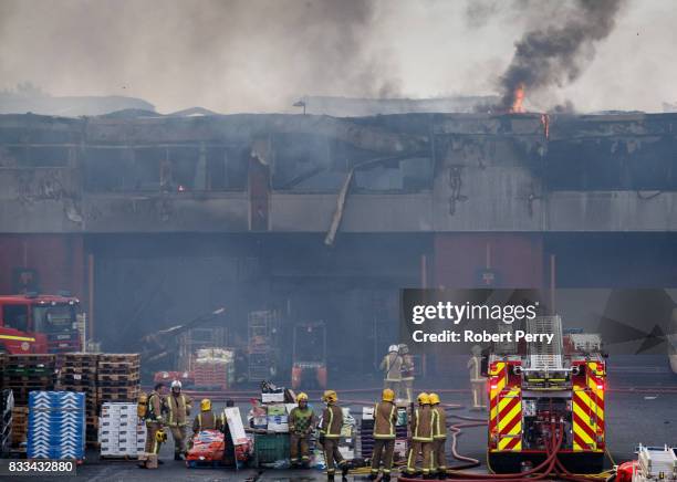 Firefighters attend the scene of a blaze at Blochairn Fruitmarket on August 17, 2017 in Glasgow. The Scottish Fire and Rescue Service are tackling a...