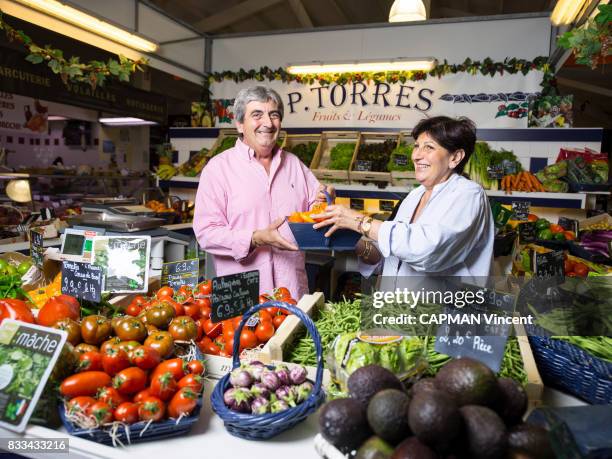 Paquita and Alain TORRES hold their fruit and vegetable stand at the Cap Ferret market on july 06, 2017 in Cap Ferret, France.