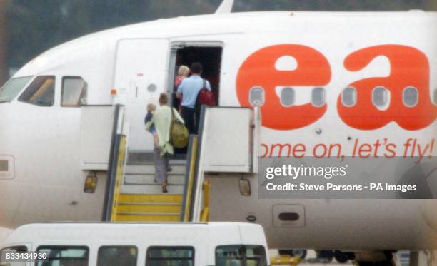 Parents of Madeleine McCann, Kate and Gerry, with their two children, Sean and Amelie, board their plane at Faro Airport before flying back to the UK.