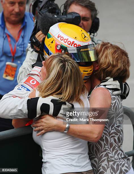 Lewis Hamilton of Great Britain and McLaren Mercedes celebrates in parc ferme with his mother Carmen Lockhart and step mother Linda Hamilton after...