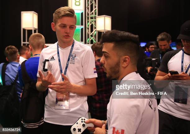 Dani "Dani" Hagebeuk of The Netherlands and Philip "FilthyP94" Balkhe of Canada speak ahead of their game during day one of the FIFA Interactive...