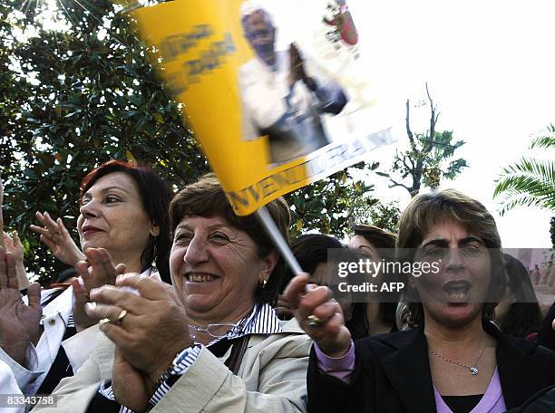 Faithful applaud and wave a flag as Pope Benedict XVI passes by in his Popemobile upon his arrival in Pompei on October 19, 2008. The Pope will...