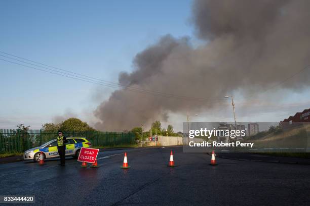 Police secure the scene of a blaze at Blochairn Fruitmarket on August 17, 2017 in Glasgow. The Scottish Fire and Rescue Service are tackling a fire...