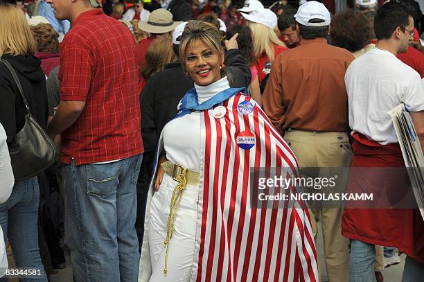 Supporter of US Republican presidential candidate John McCain is garbed in a shawl decorated in the stars and stripes of the US flag prior to...