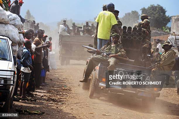 DRCongo-unrest-rebels" by BEN SIMON People watch as fighters from the National Congress for People's Defense , under the direction of renegade...