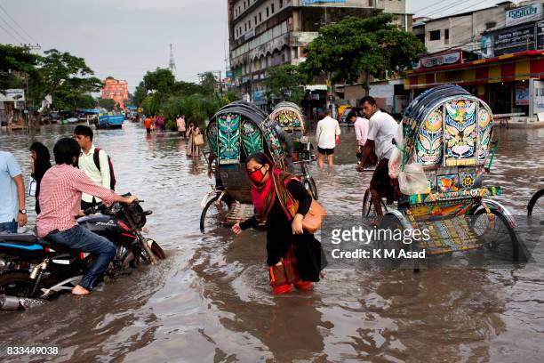 Office worker returning home in Chittagong. Chittagong city is facing unprecedented flooding this year due to rising sea level, the release of water...