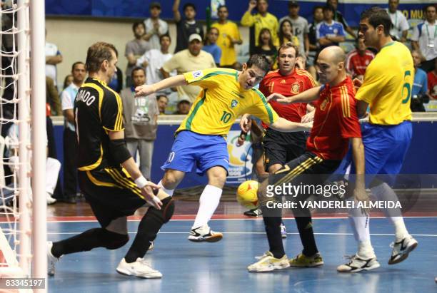 Brazil's futsal player Lenisio vies for the ball with Spain's goalkeeper Luis Amado and Javi Rodriguez on October 19, 2008 during their FIFA Futsal...