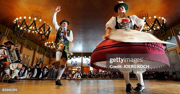 Bavarian folk dancer Herbert Reich of the "Schmied von Kochel" traditional dance association is accompanied by a so-called "Dreherin" as he performs...