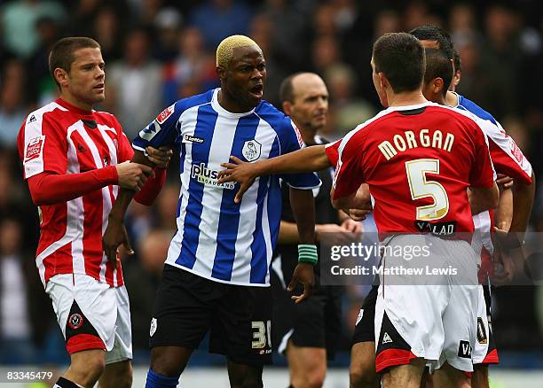 Akpo Sodje of Sheffield Wednesday is pulled away by James Beattie of Sheffield United after fighting with Ugo Ehiogu of Sheffield United during the...