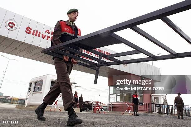 Turkish soldier carries a barrier in front of the Silivri district prison in Istanbul, as they prepare for the Ergenekon trial on October 19, 2008....