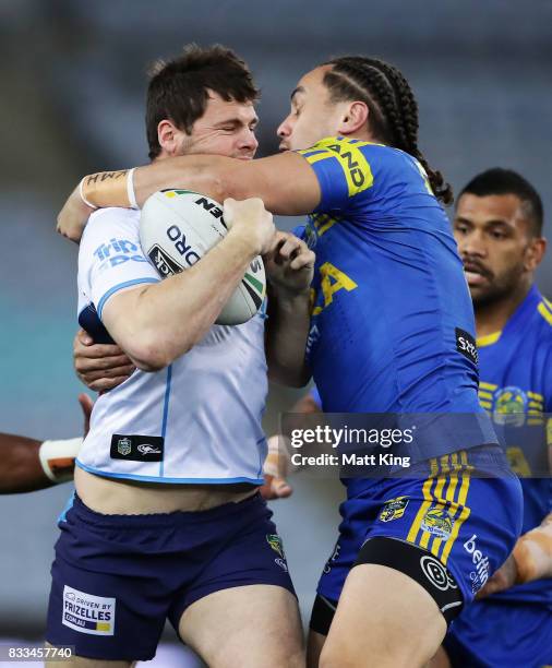 Anthony Don of the Titans is tackled by Brad Takairangi of the Eels during the round 24 NRL match between the Parramatta Eels and the Gold Coast...