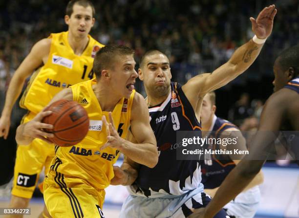 Steffen Hamann of Berlin challenges for the ball with Jeb Ivey of Bremerhaven during the Basketball Bundesliga match between Alba Berlin and...