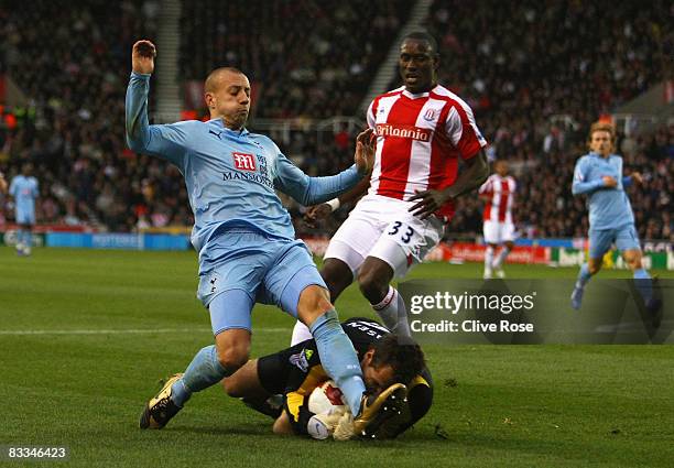 Alan Hutton of Tottenham Hotspur collides with goalkeeper Thomas Sorensen of Stoke City forcing Sorensen to leave the field during the Barclays...