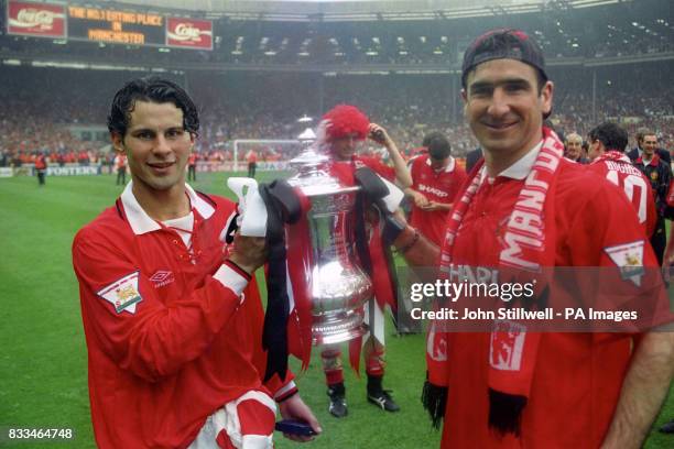 Manchester United striker Ryan Giggs holds the FA Cup after the final against Chelsea, at Wembley, which United won 4-0.