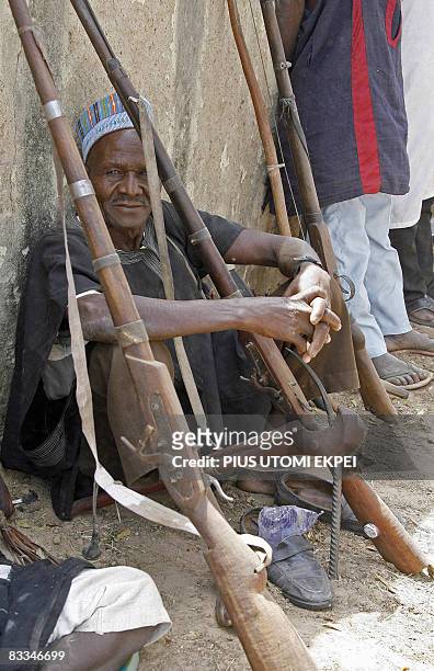 Traditional hunter sits beside dane guns as he attends the historic first the Talakawa Summit in Nigeria, a meeting between locals and government...