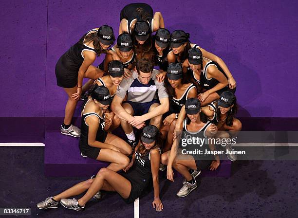 Andy Murray of Great Britain sits amid model ballgirls after his final Madrid Masters tennis tournament match against Gilles Simon of France at the...