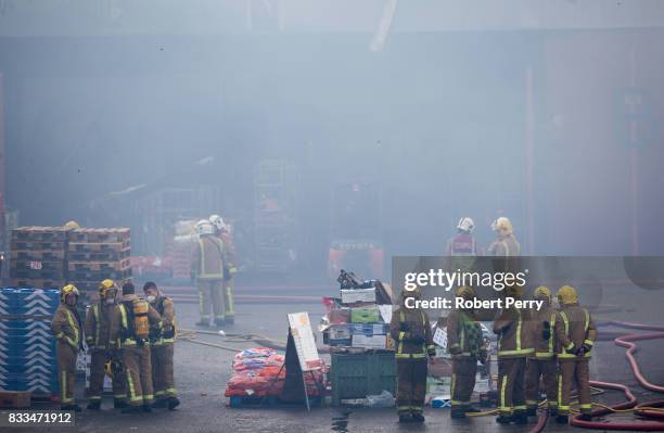 Firefighters attend the scene of a blaze at Blochairn Fruitmarket on August 17, 2017 in Glasgow. The Scottish Fire and Rescue Service are tackling a...