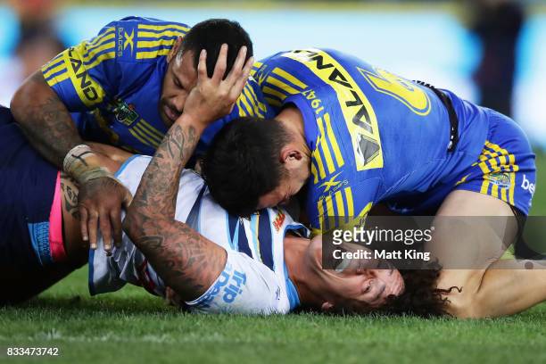 Kevin Proctor of the Titans is tackled during the round 24 NRL match between the Parramatta Eels and the Gold Coast Titans at ANZ Stadium on August...