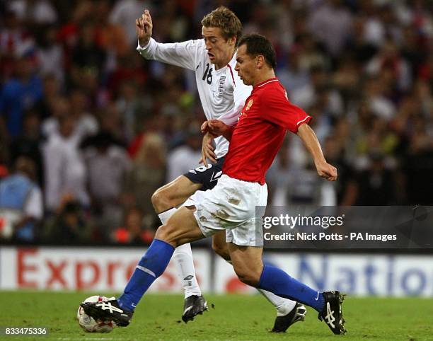 Russia's Sergei Ignashevich and England's Peter Crouch battle for the ball.