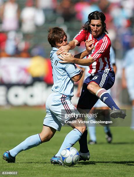 Facundo Erpen of the Colorado Rapids holds off Sacha Kljestan of CD Chivas USA from the ball in the second half of their MLS match at The Home Depot...