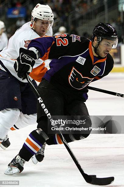 Dustin Kohn of the Bridgeport SoundTigers challenges Frederik Cabana of the Philadelphia Phantoms for possession of the puck by during the second...