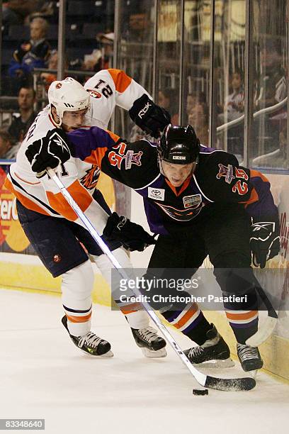 Danny Syvret of the Philadelphia Phantoms is challenged for possession of the puck by Jeremy Colliton of the Bridgeport Sound Tigers during the first...