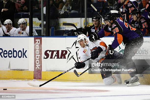 Blake Comeau of the Bridgeport Sound Tigers is checked by Sean Curry of the Philadelphia Phantoms while playing for possession of the puck during the...