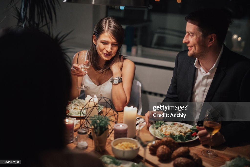 Smiling couple on a double date with friends.