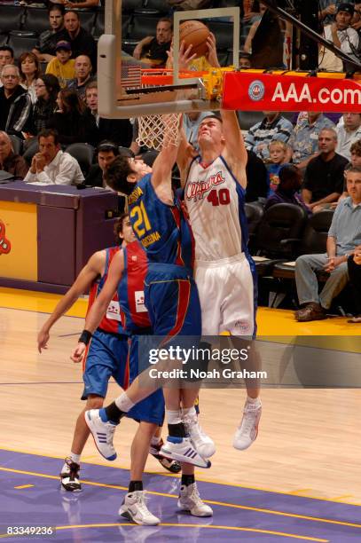 Paul Davis of the Los Angeles Clippers has his shot challenged by Ersan Ilyasova of Regal FC Barcelona at Staples Center on October 19, 2008 in Los...