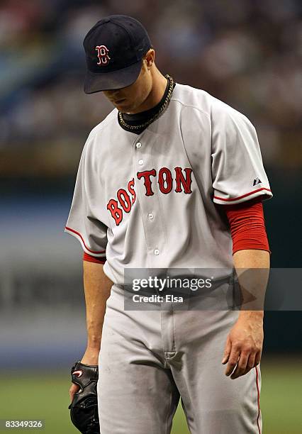 Starting pitcher Jon Lester of the Boston Red Sox walks off of the field against the Tampa Bay Rays in game seven of the American League Championship...