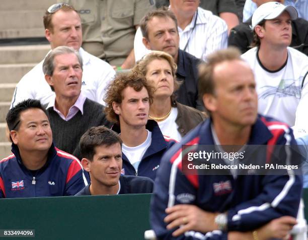 Tim Henman and Andy Murray watch Jamie Baker in action during the third day of the Davis Cup World Group Play-off at the All England Club, Wimbledon.