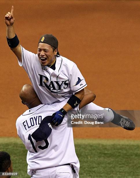 Akinori Iwamura and Cliff Floyd of the Tampa Bay Rays celebrate after defeating the Boston Red Sox in game seven of the American League Championship...