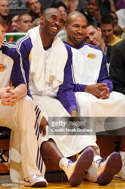 Kobe Bryant and Derek Fisher of the Los Angeles Lakers smile from the bench during their game against the Toronto Raptors at Staples Center on...
