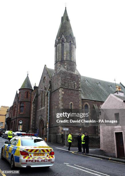 Police stand on guard during the funeral of Ben Porcelli, who died in a helicopter crash with rally driver Colin McRae, at Greyfriars Kirk, Lanark.