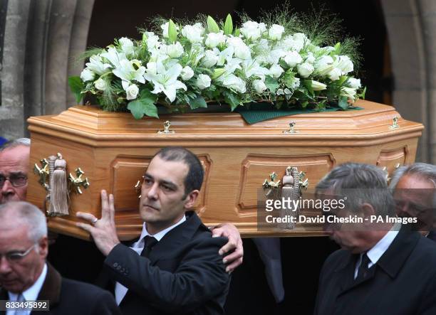 Mark Porcelli helps to carry the coffin, following the funeral of his son Ben Porcelli, who died in a helicopter crash with rally driver Colin McRae,...