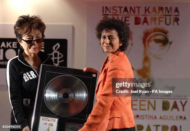 Irene Khan Secretary General of Amnesty International, presents Yoko Ono with the 'Instant Karma' record, featuring more than 20 John Lennon songs...