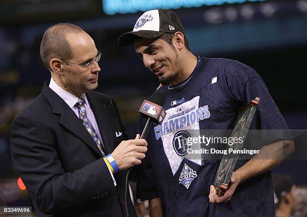 Television personality Ernie Johnson talks with pitcher Matt Garza of the Tampa Bay Rays after defeating the Boston Red Sox in game seven of the...