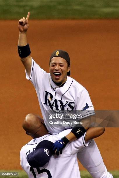 Akinori Iwamura and Cliff Floyd of the Tampa Bay Rays celebrate after defeating the Boston Red Sox in game seven of the American League Championship...