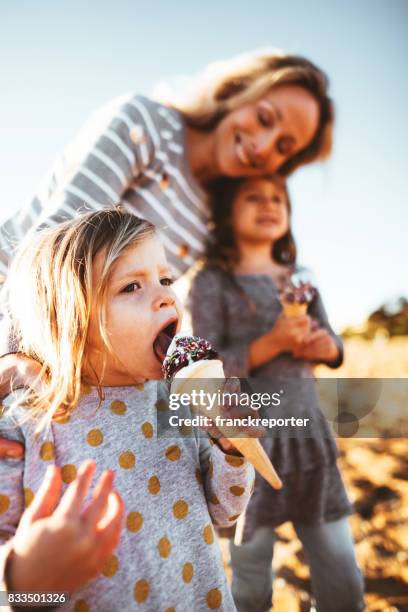 happy family eating the icecream on the beach - ice cream family stock pictures, royalty-free photos & images